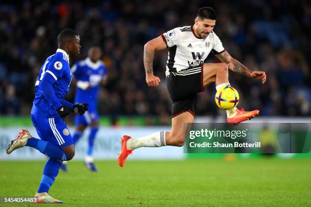 Aleksandar Mitrovic of Fulham controls the ball whilst under pressure from Nampalys Mendy of Leicester City during the Premier League match between...