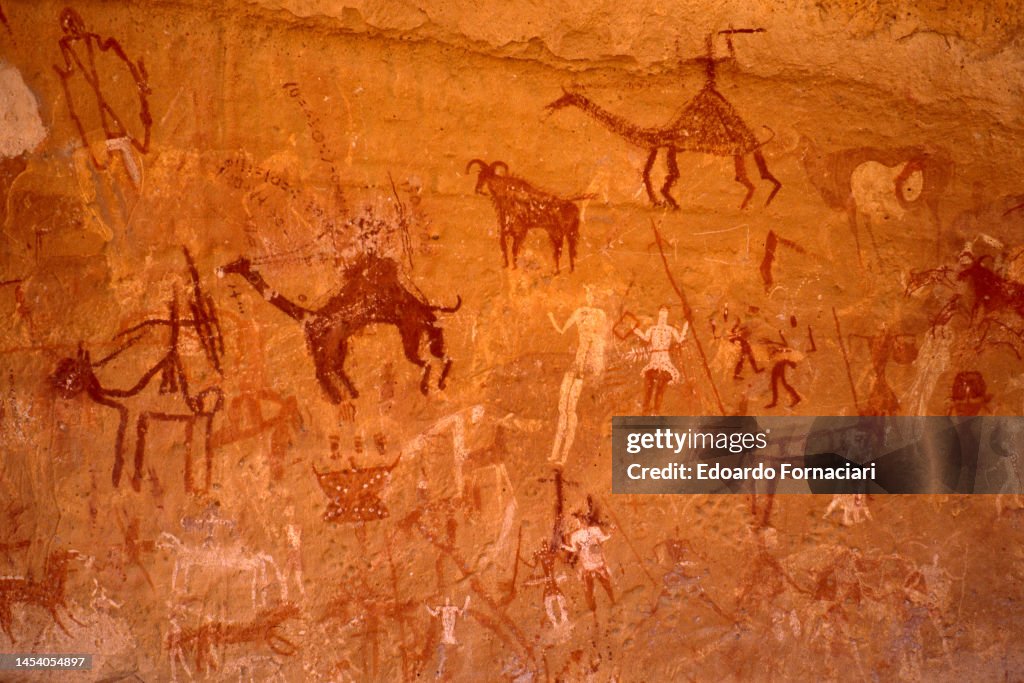 Label Acacus Close-up of primitive paintings on rock wall in the Acacus Mountains ...