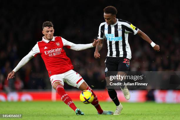 Joe Willock of Newcastle United is challenged by Ben White of Arsenal during the Premier League match between Arsenal FC and Newcastle United at...