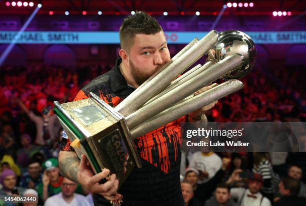 Michael Smith of England celebrates with the Trophy during the Finals against Michael van Gerwen of Netherlands during Day Fourteen of the Cazoo...