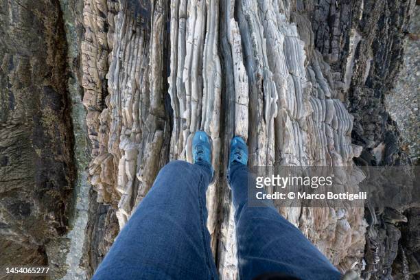 personal perspective of person standing above sharp rock formations - pointed foot stock pictures, royalty-free photos & images