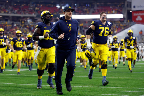 Head coach Jim Harbaugh of the Michigan Wolverines leaves the field before the Vrbo Fiesta Bowl against the TCU Horned Frogs at State Farm Stadium on...
