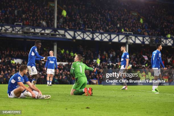 Jordan Pickford and Idrissa Gueye of Everton react after Brighton & Hove Albion's fourth goal during the Premier League match between Everton FC and...