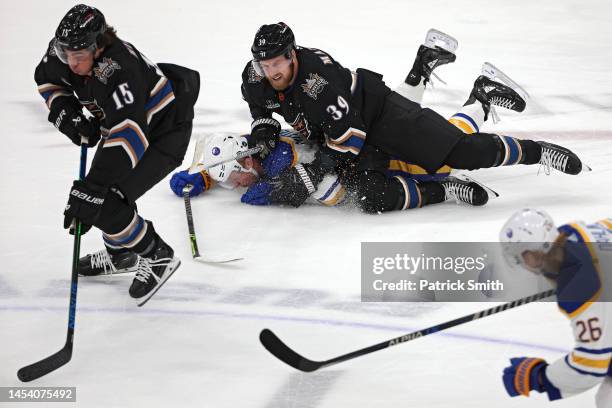 Anthony Mantha of the Washington Capitals checks Casey Mittelstadt of the Buffalo Sabres during the first period at Capital One Arena on January 3,...