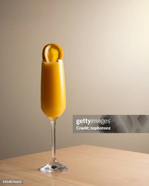 mimosa/ orange juice cocktail in champagne glass (food and drink photography, click for more) - champagne brunch stock pictures, royalty-free photos & images