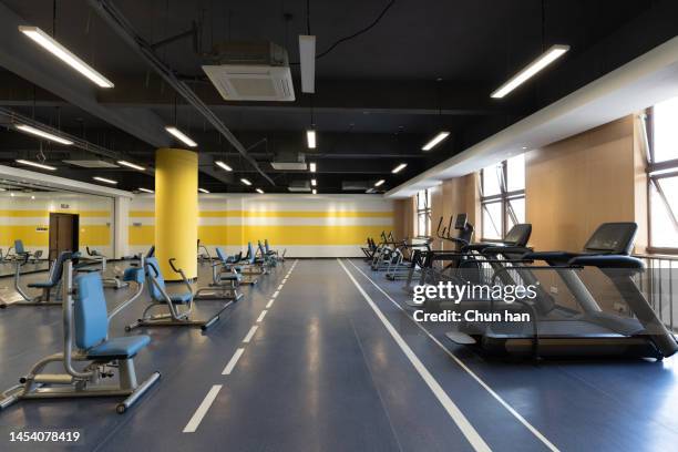 many fitness equipment in the empty gym - exercise room stock pictures, royalty-free photos & images