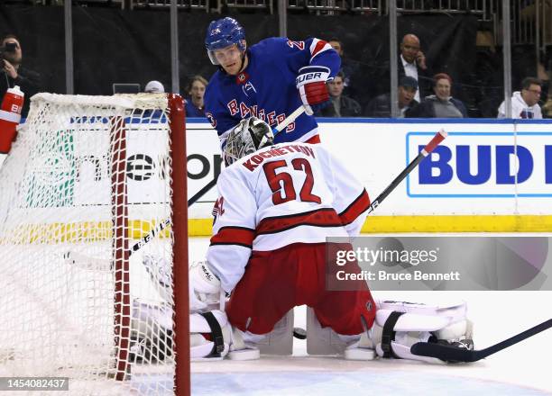 Pyotr Kochetkov of the Carolina Hurricanes squeezes the pads on a second period shot by Adam Fox of the New York Rangers at Madison Square Garden on...