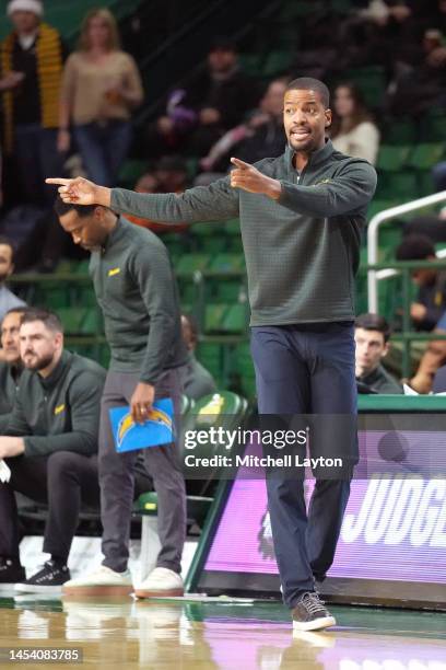 Head coach Kim English of the George Mason Patriots signals to his players during a college basketball game against the Coppin State Eagles at Eagle...