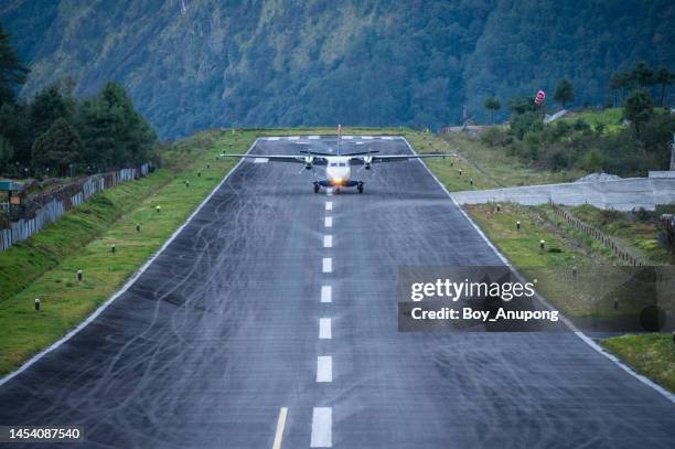 plane landing on the runway of lukla airport one of the most dangerous airport in the world. - life threatening stock pictures, royalty-free photos & images