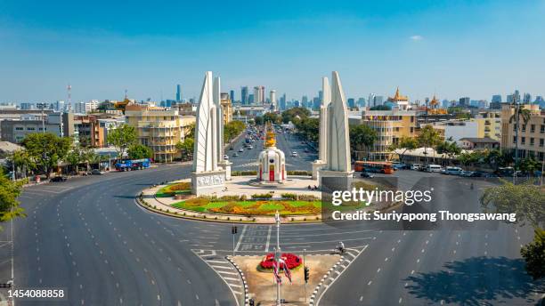 democracy monument with cityscape background at ratchadamnoen road in bangkok, thailand. - democracy monument stock pictures, royalty-free photos & images