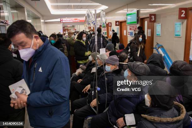 Patients sit at the emergency hall of Huashan Hospital affiliated to Fudan University for infusion on January 3, 2023 in Shanghai, China. Hospitals...