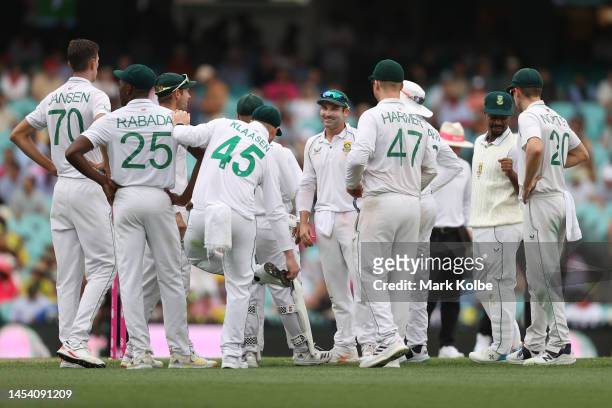 Dean Elgar of South Africa waits with team mates for a DRS review during day one of the Third Test match in the series between Australia and South...