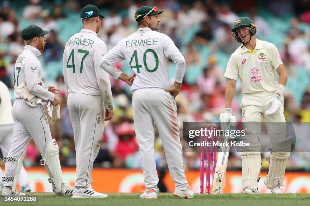 Marnus Labuschagne of Australia speaks with Kyle Verreynne and Simon Harmer of South Africa during day one of the Third Test match in the series...