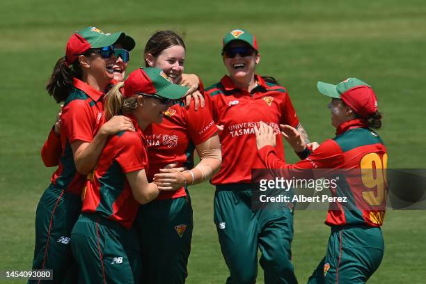 Julia Cavanough of Tasmania celebrates with team mates after dismissing Charli Knott of Queensland during the WNCL match between Queensland and...