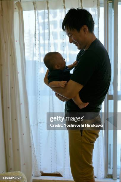 father looking after new family - baby father hug side stock pictures, royalty-free photos & images