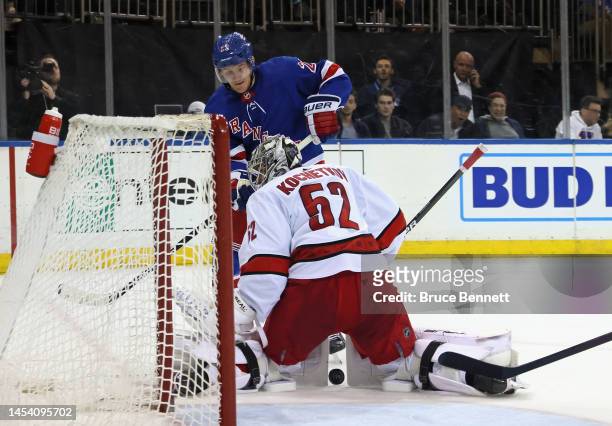 Pyotr Kochetkov of the Carolina Hurricanes squeezes the pads on a second period shot by Adam Fox of the New York Rangers at Madison Square Garden on...