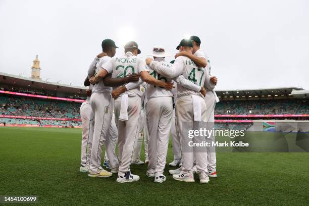 Players of South Africa huddle during day one of the Third Test match in the series between Australia and South Africa at Sydney Cricket Ground on...