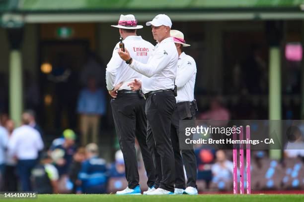 Umpires test the light conditions during day one of the Third Test match in the series between Australia and South Africa at Sydney Cricket Ground on...