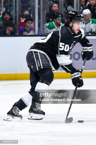 Sean Durzi of the Los Angeles Kings skates with the puck during the second period against the Dallas Stars at Crypto.com Arena on January 3, 2022 in...
