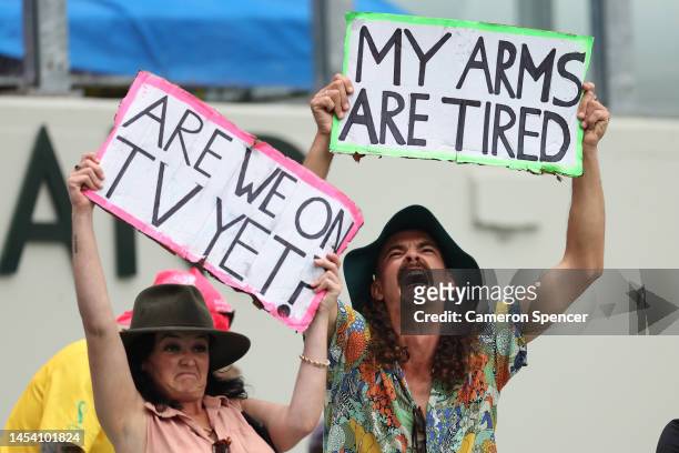 Fans hold signs during day one of the Third Test match in the series between Australia and South Africa at Sydney Cricket Ground on January 04, 2023...