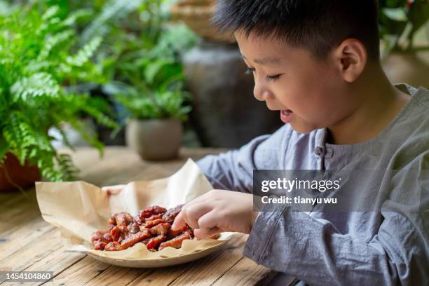 an asian boy was tasting barbecue - rice cereal cartoon stock pictures, royalty-free photos & images