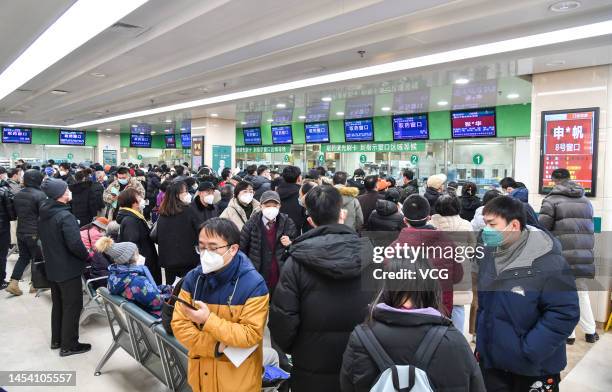 Patients wait to fetch medicine at Peking University Third Hospital on January 3, 2023 in Beijing, China. Hospitals in Beijing have been working at...