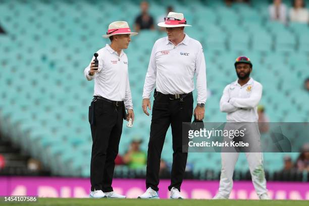 Umpire Chris Gaffaney measures the light during day one of the Third Test match in the series between Australia and South Africa at Sydney Cricket...