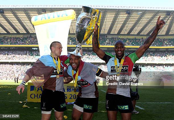 Mike Brown, Jordan Turner-Hall and Ugo Monye of Harlequins celebrate with the trophy following their team's victory during the Aviva Premiership...