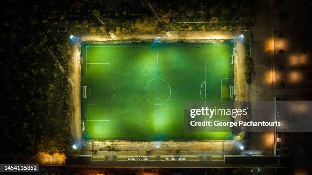 aerial photo of illuminated soccer field at night - aerial view of football field stockfoto's en -beelden