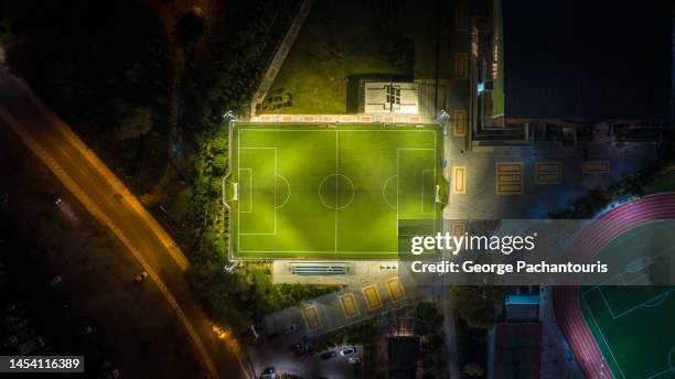 aerial photo of illuminated soccer field at night - street football stock pictures, royalty-free photos & images