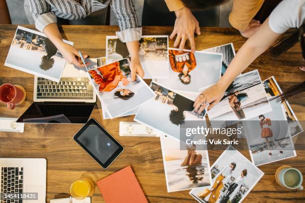a team choosing a magazine cover - magazine editor stock pictures, royalty-free photos & images