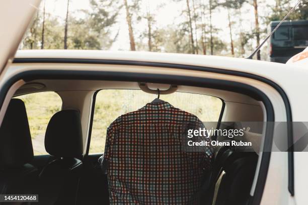 striped shirt hanging in the car - polo shirt bildbanksfoton och bilder