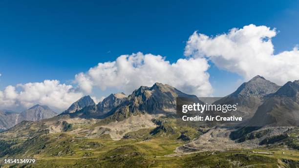 drone shot of a rocky mountain range - aerial view of clouds and earth landscape stock pictures, royalty-free photos & images