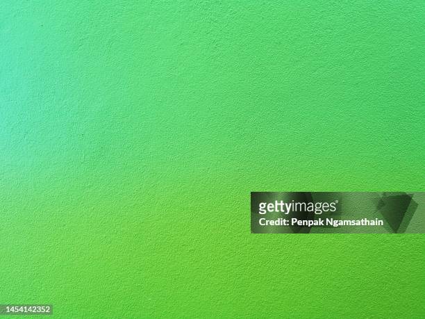 paint green color on the cement wall has gray color and rough abstract surface texture concrete material background - kelly green stock-fotos und bilder