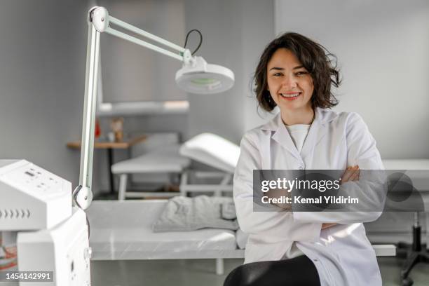 beautiful dermatologist at her practice - dermatologie stockfoto's en -beelden