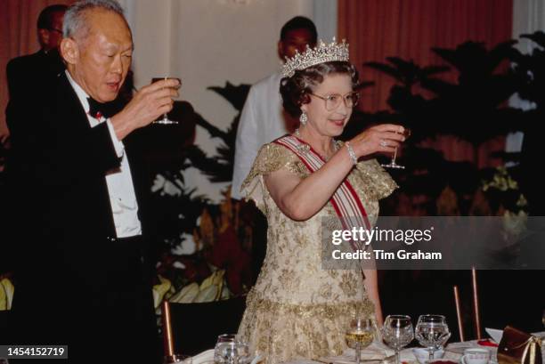 Prime Minister Lee Kuan Yew and Queen Elizabeth II, wearing the Girls of Great Britain and Ireland diamond tiara, attend a State Banquet during the...