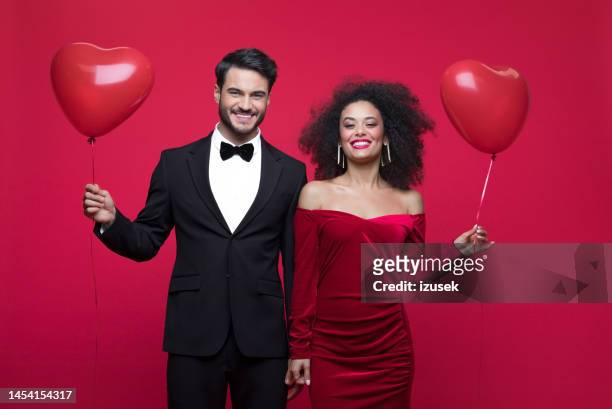 beautiful couple celebrating valentine's day - black balloons stock pictures, royalty-free photos & images