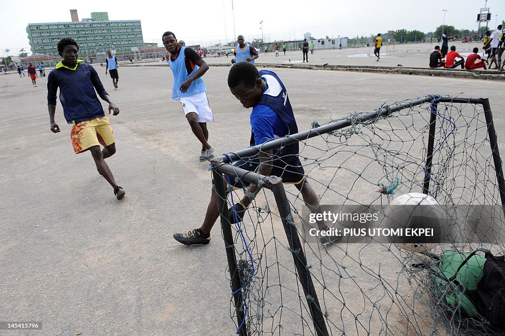 Nigerian youths compete for the ball as 