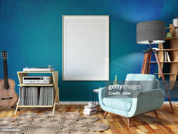 relaxing at home concept with cozy living room full of books armchair music player and a empty picture frame - blue living room stock pictures, royalty-free photos & images