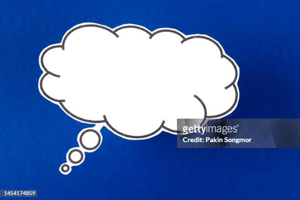 the words talking and speaking are conveyed by a speech bubble with copy space on a blue color background. - thought bubbles stock-fotos und bilder