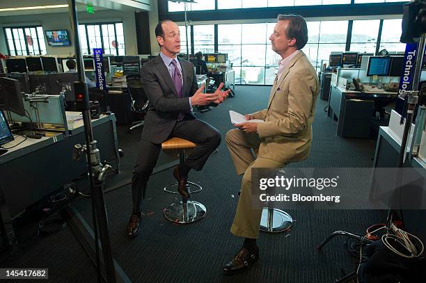 Enrique Salem, chief executive officer of Symantec Corp., left, speaks during a Bloomberg West television interview in San Francisco, California,...