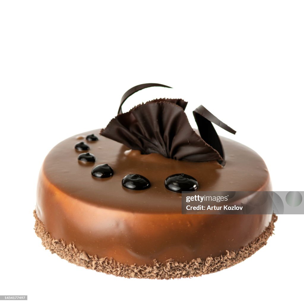 Chocolate cake in chocolate icing. Birthday cake. Celebratory dessert. Copy space. Isolate on white background