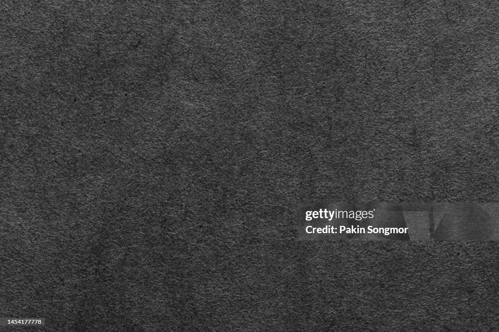 Black paper sheet texture cardboard background.