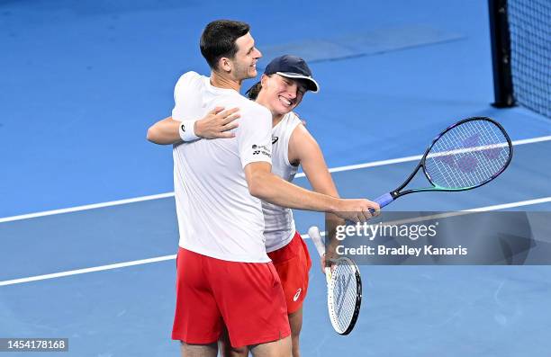 Iga Swiatek and Hubert Hurkacz of Poland celebrate victory after their mixed doubles match against Camilla Rosatello and Lorenzo Musetti of Italy...