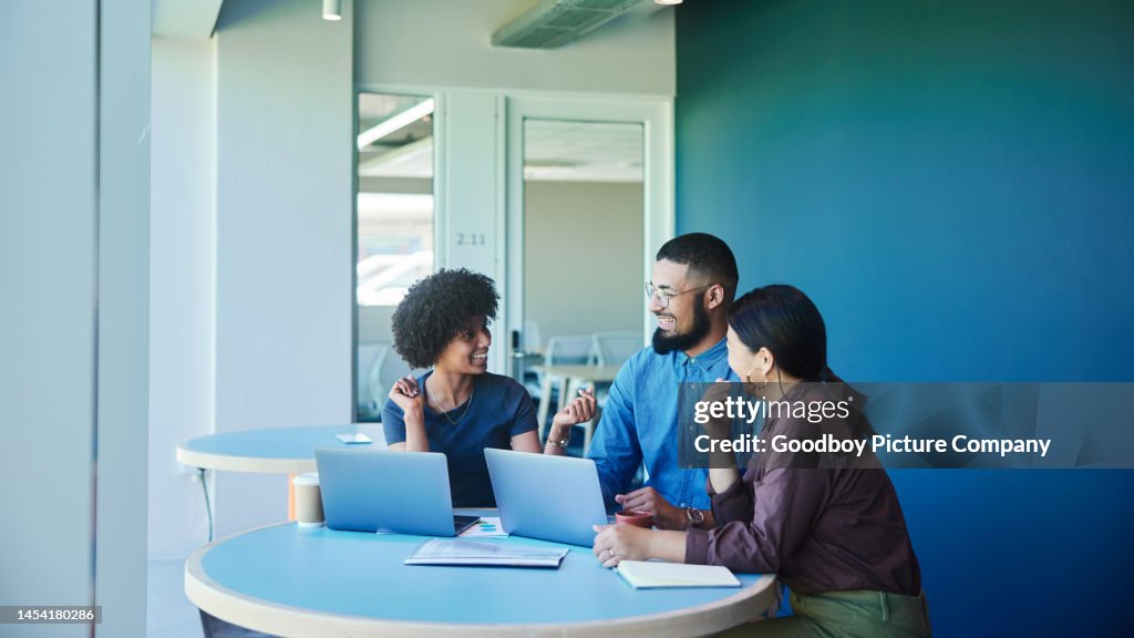 Young businesspeople laughing during a casual meeting in an office