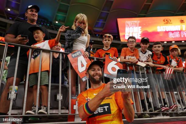 Andrew Tye of the Scorchers takes selfies with fans after the Men's Big Bash League match between the Perth Scorchers and the Sydney Thunder at Optus...