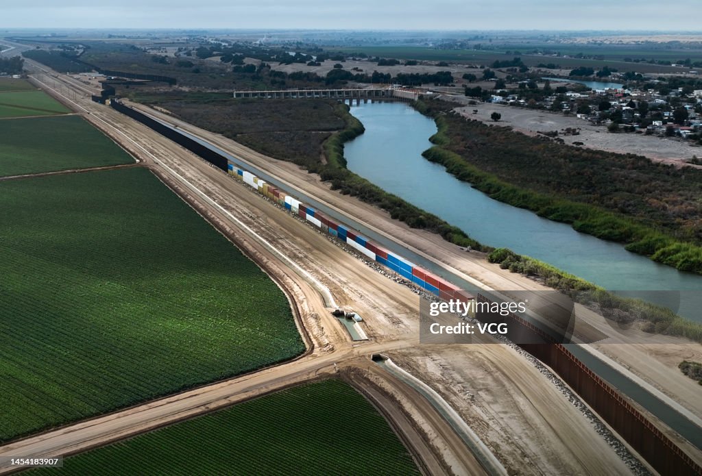 Container Border Aerial view of shipping containers being installed to fill gaps in ...