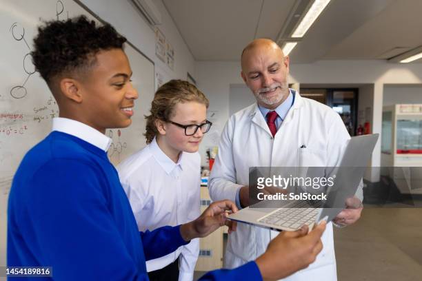 going through students work with them - teachers pet stock pictures, royalty-free photos & images