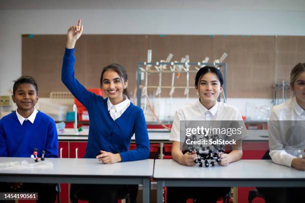 hand up in school with confidence - school uniform stock pictures, royalty-free photos & images