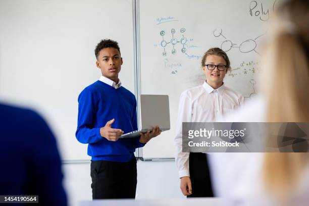 scientific presentation with a friend - boy girl stock pictures, royalty-free photos & images
